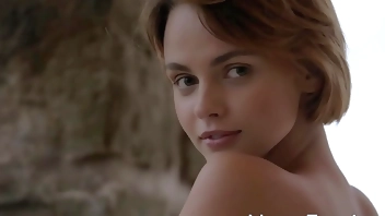 Short haired stunner presents her shaved pussy outdoors