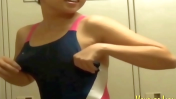 Asians in locker room change into swimsuits