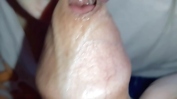 Very close-up of a girl doing blowjob early in the morning - cum in mouth from sweet lips and tongue