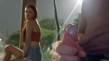 Risky handjob on the street for hot redhead at the bus stop