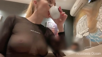 Flashing her big boobs in transparent top in public cafe.
